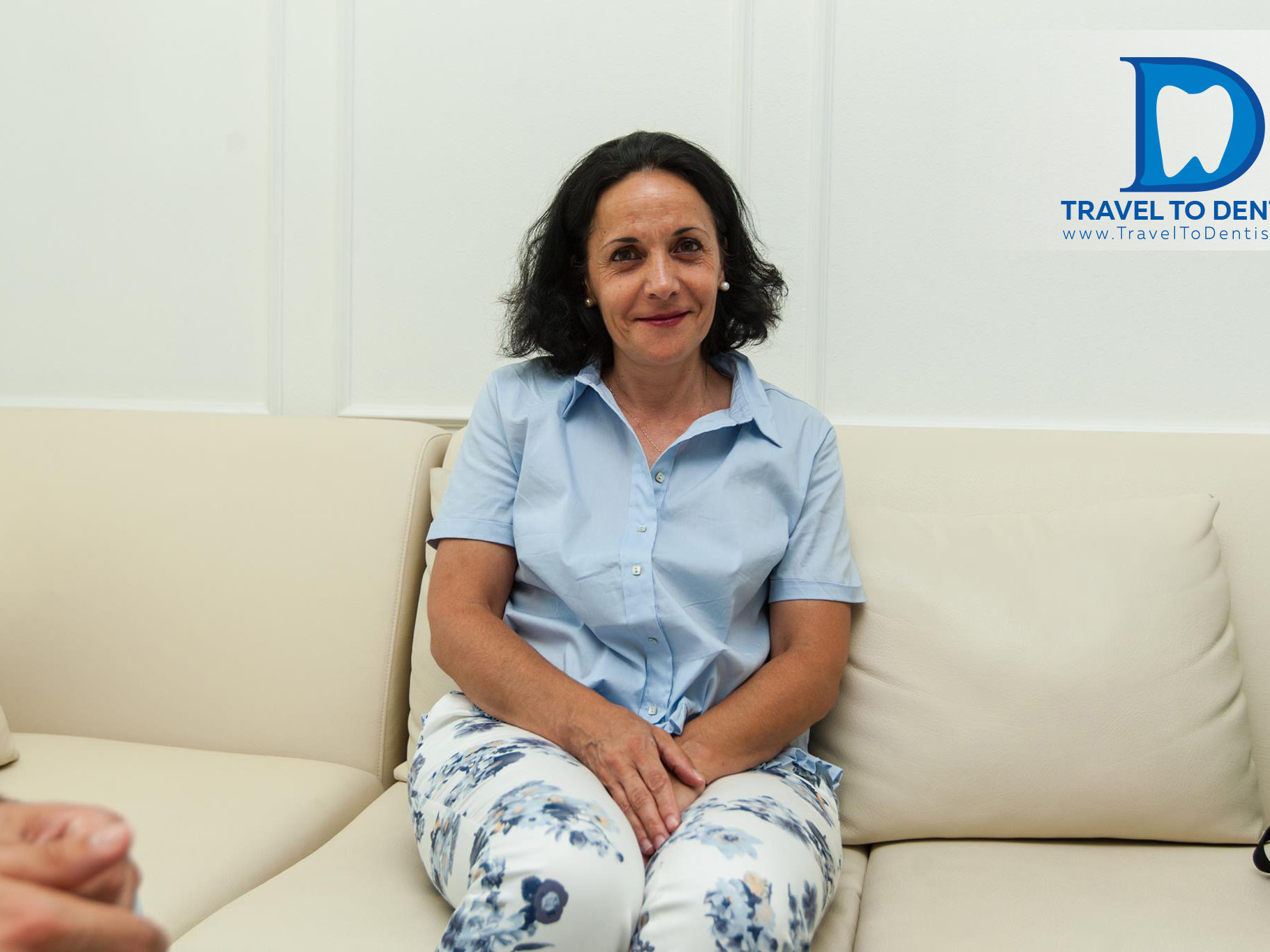 The patient from Italy is waiting for the appointment with the moldovan dentist, sitting on a comfortable sofa